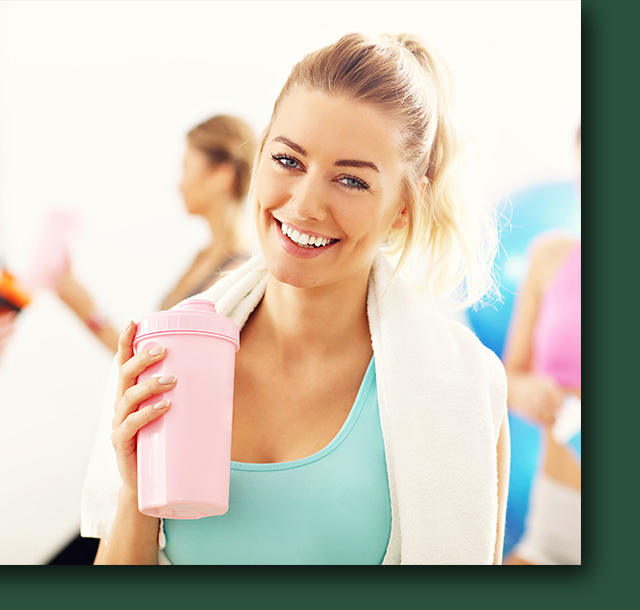 a woman holding water bottle after exercise